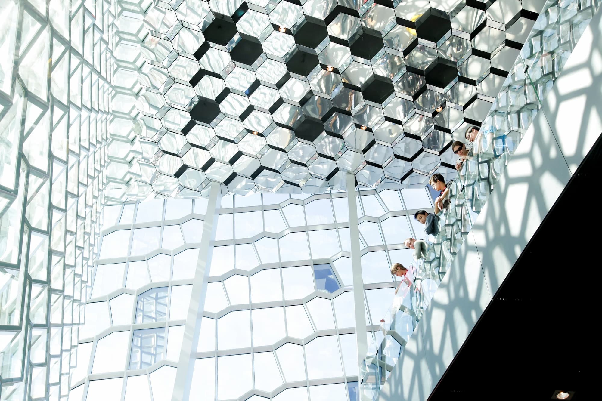 a group of people are standing on a set of stairs in a building .