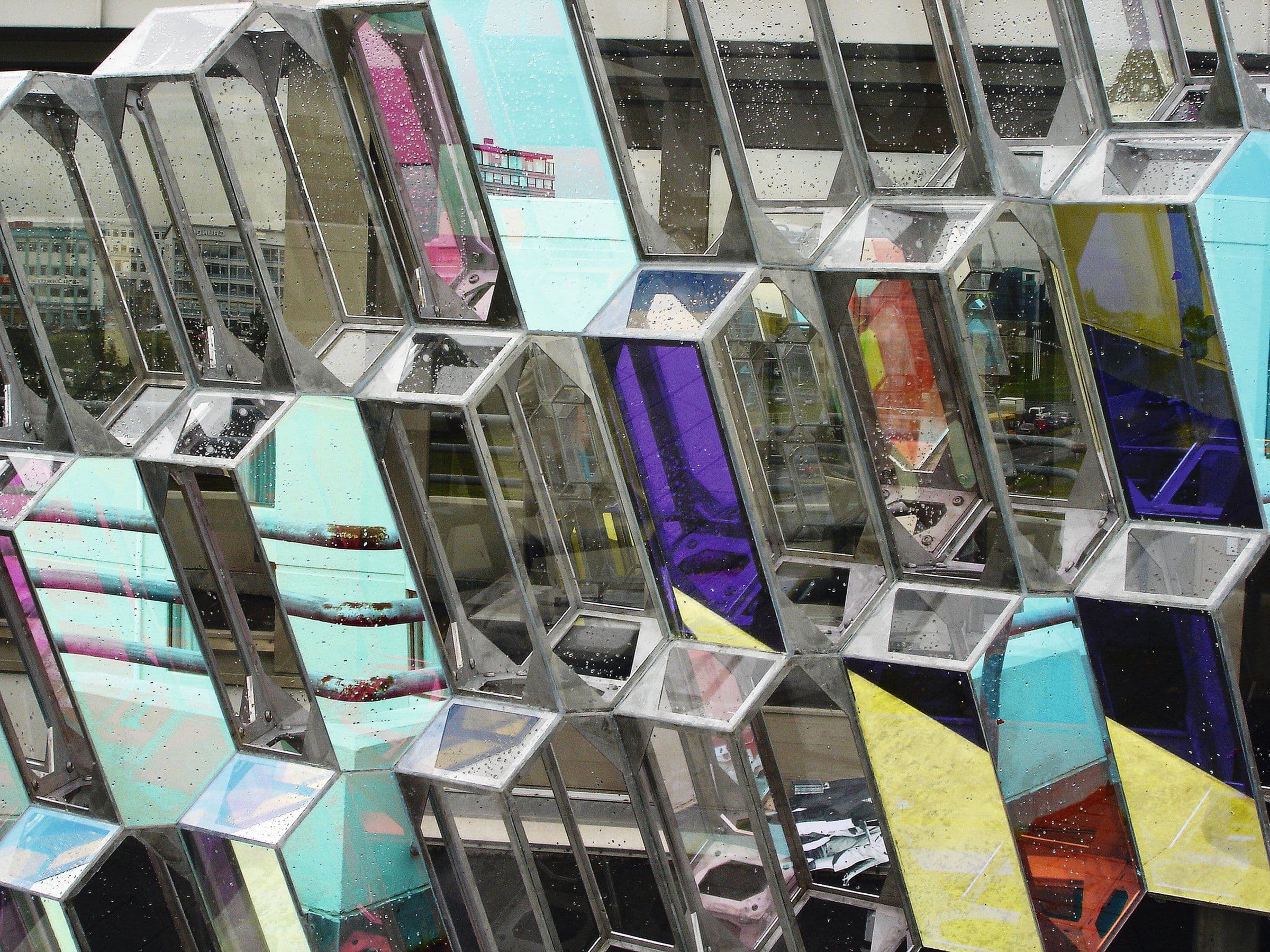 a building with a lot of mirrors on it that looks like a honeycomb .